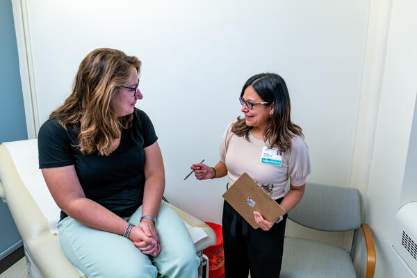Clinician talks to patient in exam room