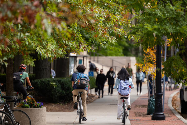 Students ride bicycles on MIT Campus