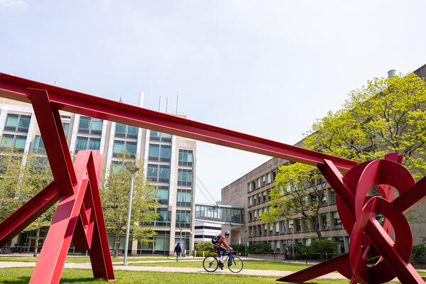 View of an red metal outdoor sculpture on MIT campus