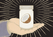 A mason jar containing half of a coconut held in the palm of an open hand
